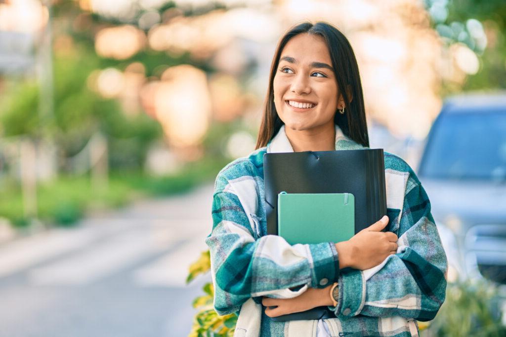 Smiling Woman Holding Books